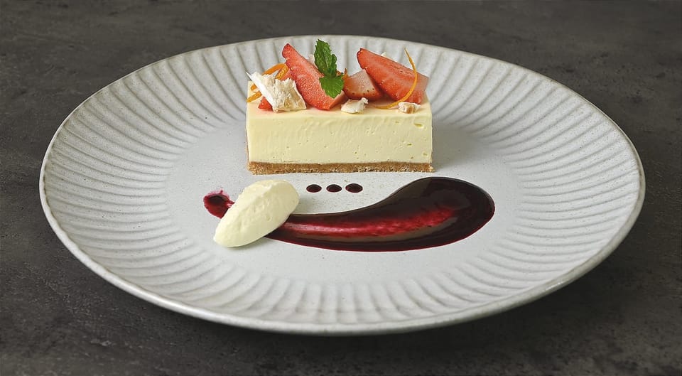 Decadent Vanilla Cheesecake with Berry Coulis